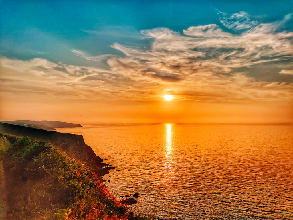 sunset over the sea and cliffs