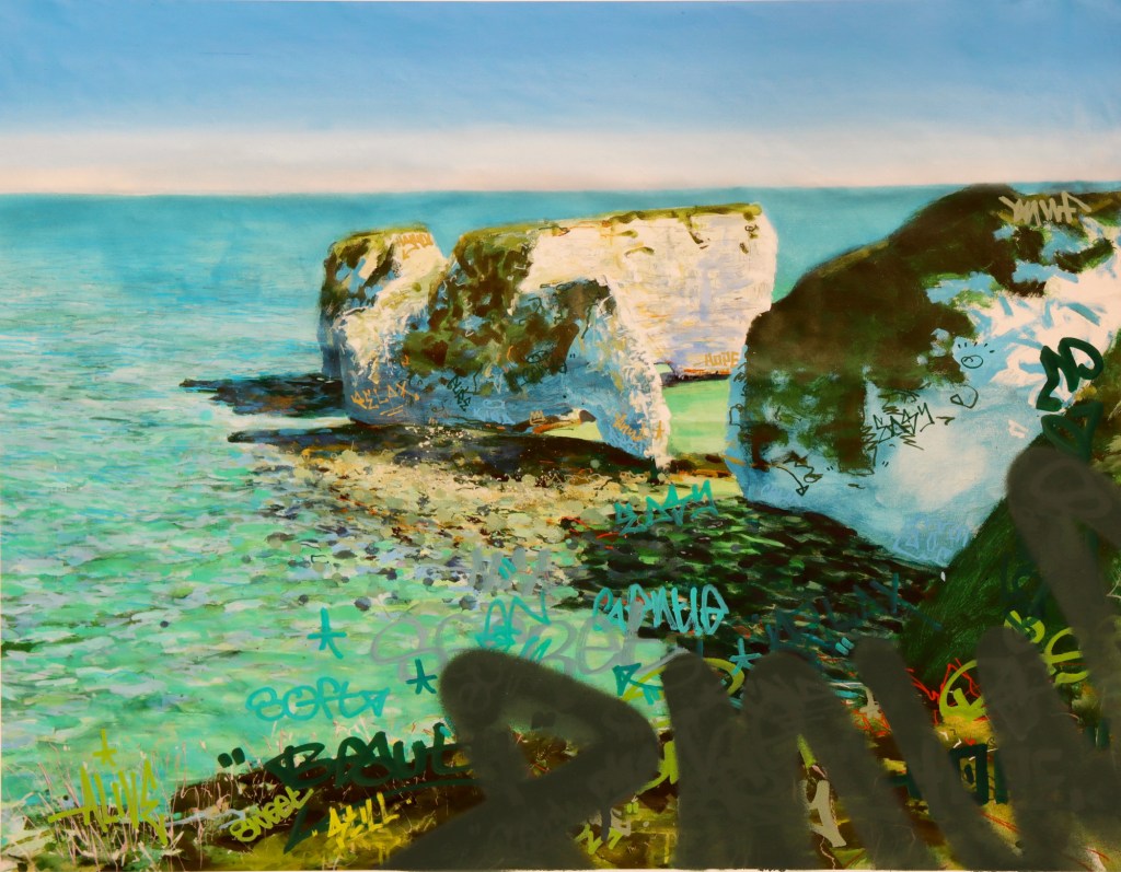 A coastal scene featuring rocky formations partially covered in colorful graffiti, with clear turquoise water and a bright blue sky.